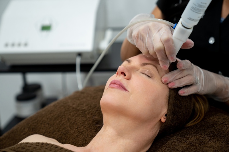 Beautiful woman at the spa getting a facial laser treatment IN Orlando, FL