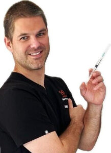 Photo of Nick holding a syringe